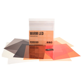 LEE Filters Zircon Warm LED Lighting Gel Pack with its clear packaging box and several translucent orange, red, and amber gel sheets arranged in front on a white background.
